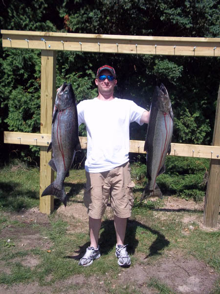 A king salmon in each hand - Leprechaun Fishing Charters on Lake Michigan